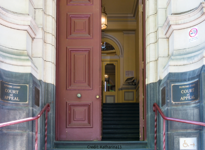 Stairs leading to open court doors, tall and red