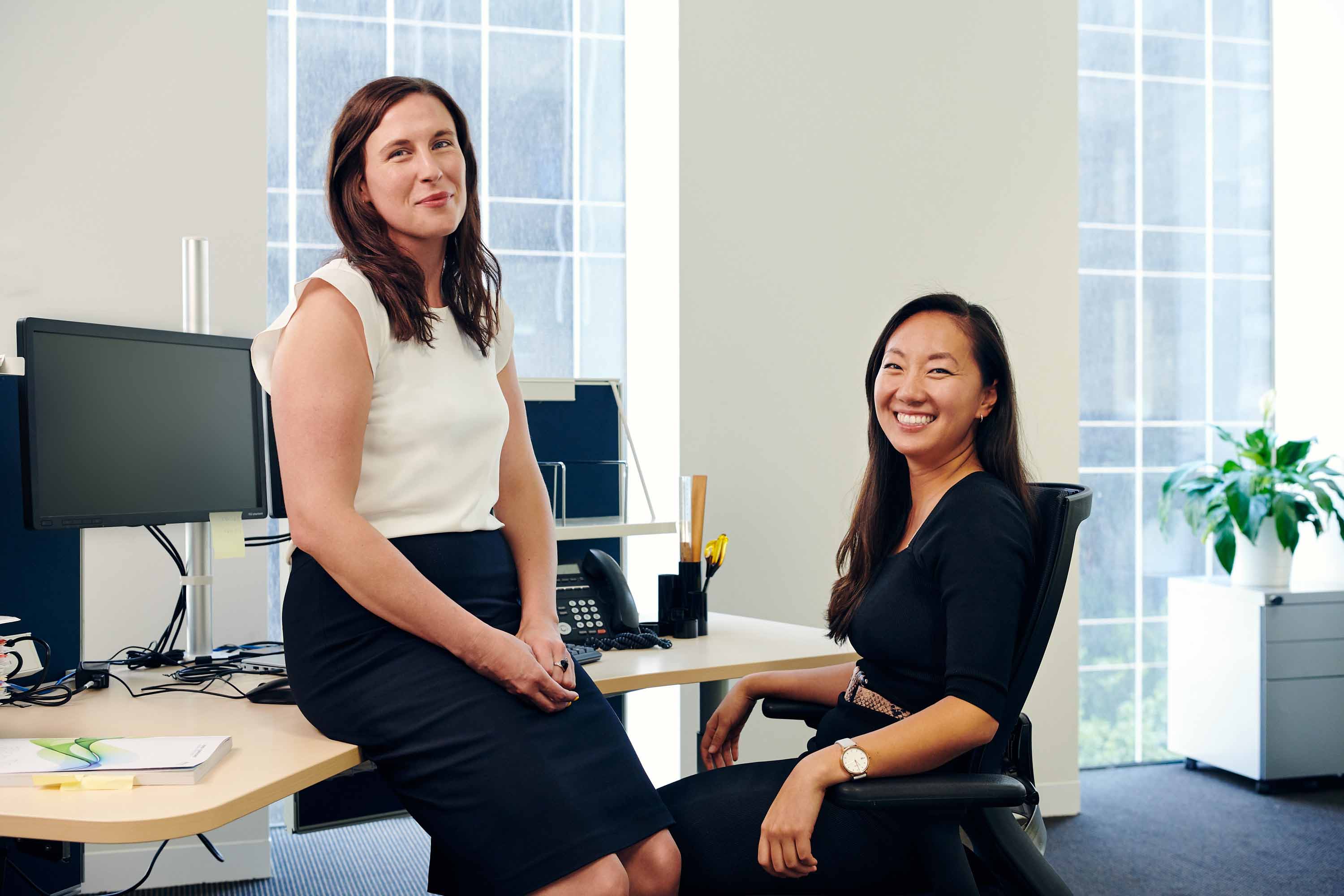 Two VLSB+C staff members standing at a desk
